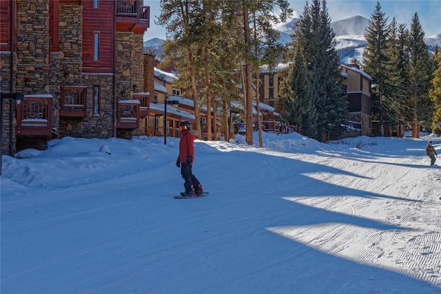 yard covered in snow with a mountain view