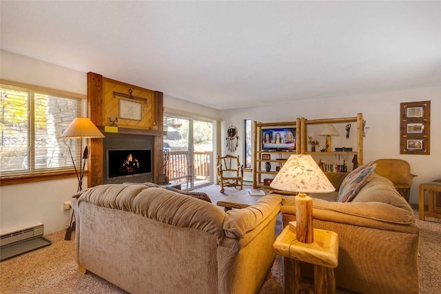 carpeted living room featuring a fireplace and a baseboard heating unit