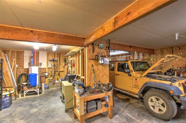 garage with a workshop area and wooden walls