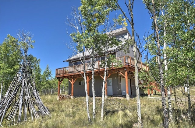 rear view of house with a wooden deck