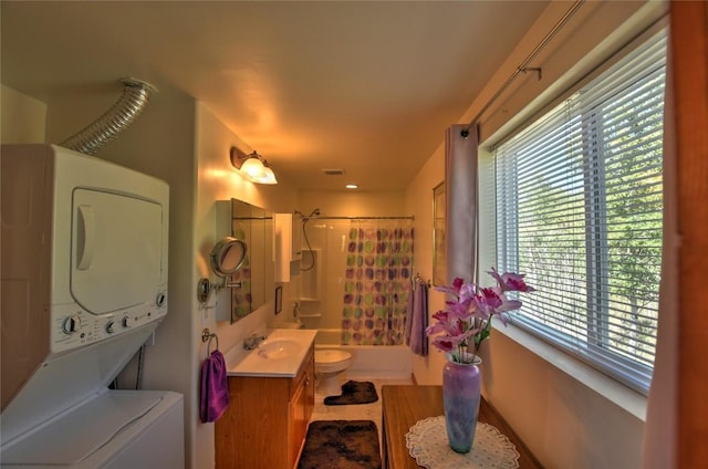 full bathroom featuring shower / bath combo with shower curtain, vanity, a wealth of natural light, and stacked washer / drying machine