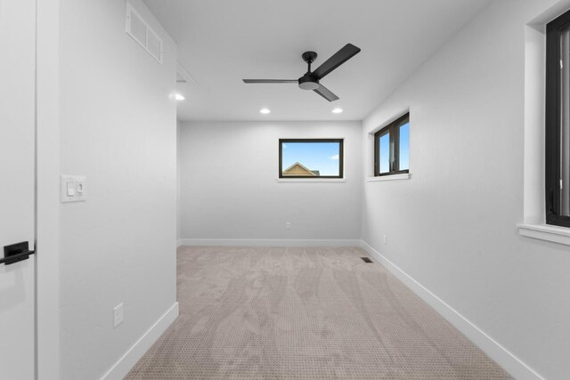 unfurnished room with ceiling fan and light carpet