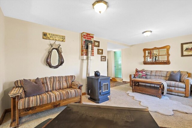 carpeted living room featuring a wood stove