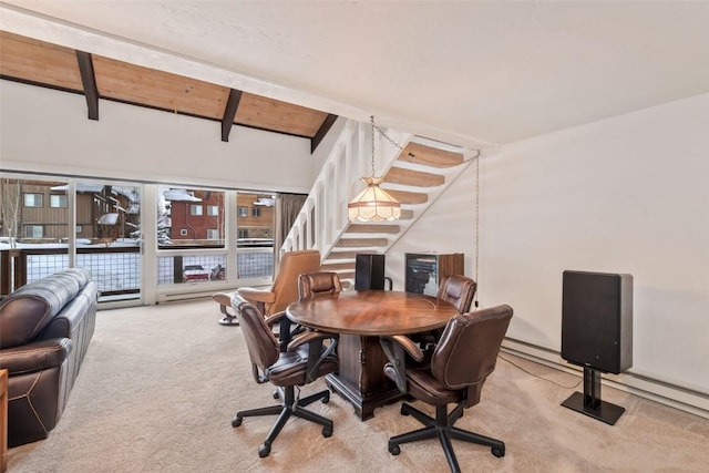 carpeted dining room with beamed ceiling