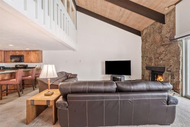 living room with beam ceiling, high vaulted ceiling, light carpet, a stone fireplace, and wooden ceiling