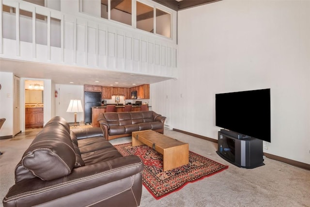 carpeted living room with a high ceiling