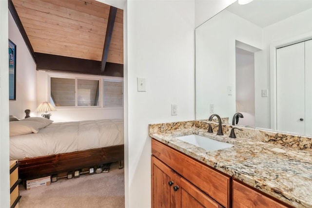 bathroom featuring wood ceiling, vanity, and vaulted ceiling with beams