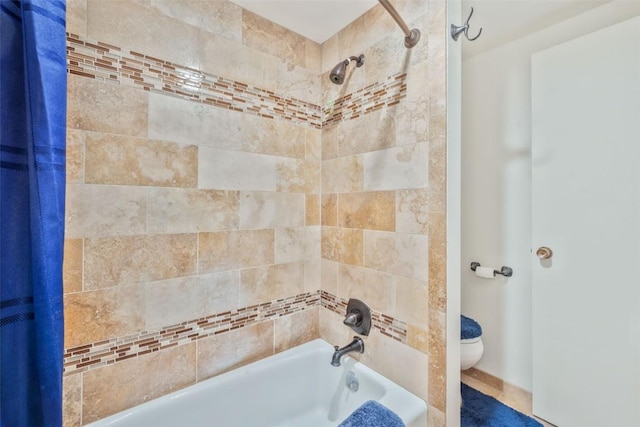 bathroom featuring toilet and shower / bath combo