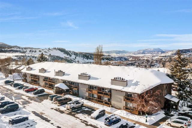 snowy aerial view with a mountain view