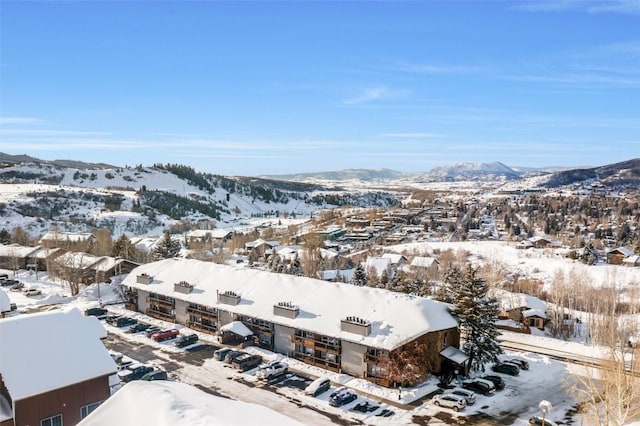 snowy aerial view featuring a mountain view