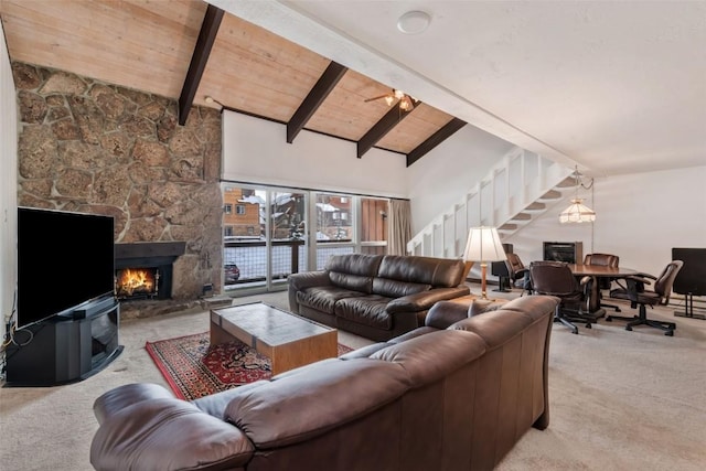 carpeted living room featuring wood ceiling, a stone fireplace, high vaulted ceiling, and beamed ceiling