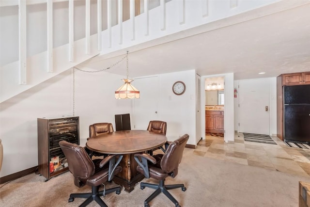 dining room with light colored carpet and beverage cooler