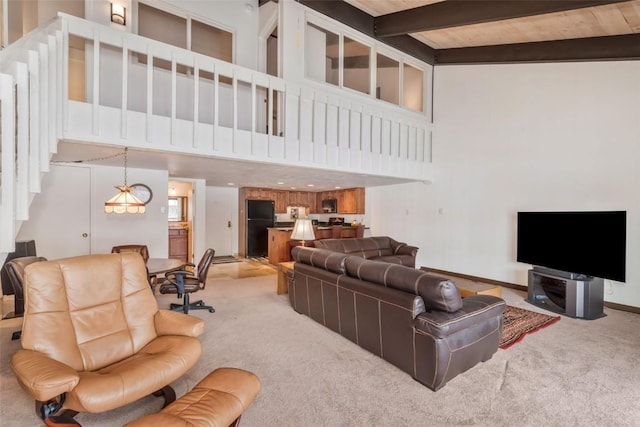 carpeted living room with a high ceiling, wooden ceiling, and beam ceiling