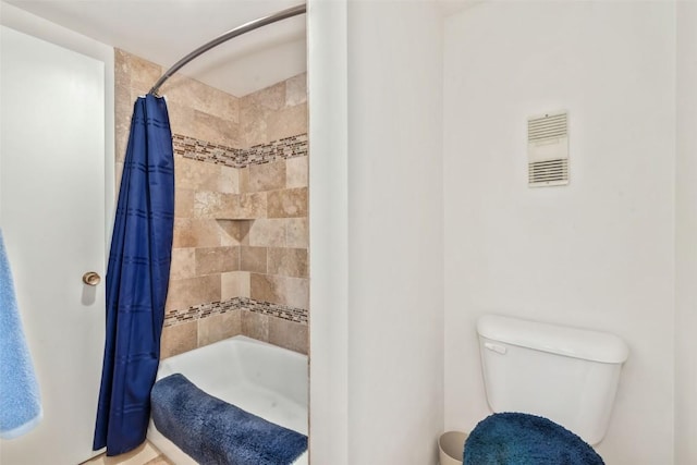 bathroom with toilet and shower / bath combo with shower curtain