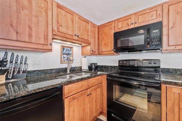 kitchen with dark stone countertops, sink, and black appliances