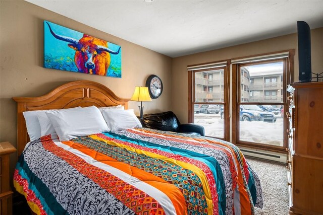 carpeted bedroom with a baseboard radiator