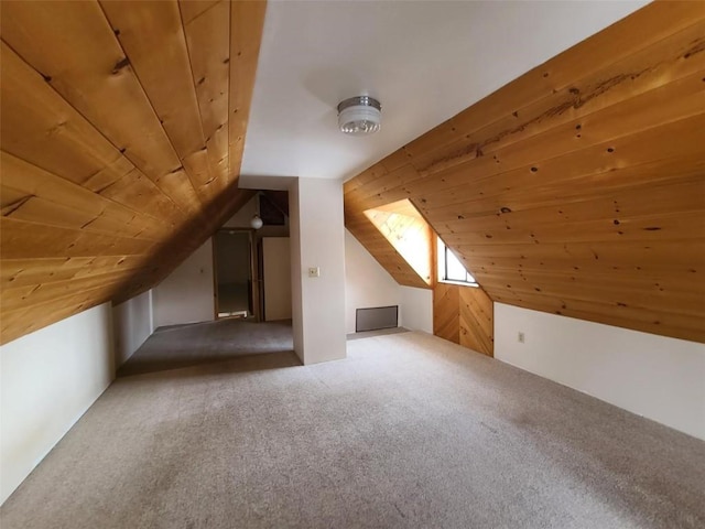 bonus room featuring lofted ceiling, carpet floors, and wooden ceiling