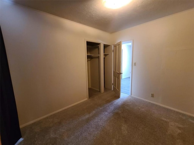 unfurnished bedroom featuring carpet floors, a closet, and a textured ceiling