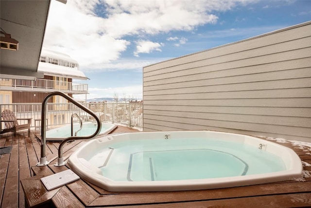 wooden terrace with an outdoor hot tub