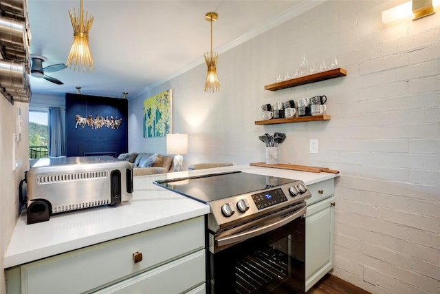 kitchen with hanging light fixtures, crown molding, ceiling fan, stainless steel electric range oven, and brick wall