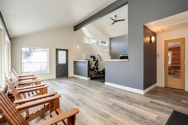 foyer entrance with vaulted ceiling with beams, ceiling fan, and hardwood / wood-style floors