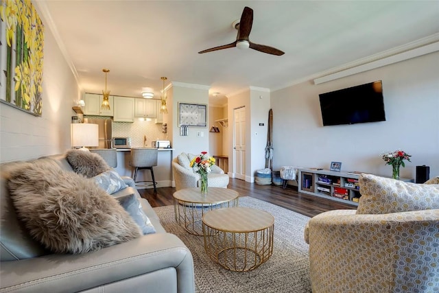 living room with ceiling fan, dark hardwood / wood-style flooring, and crown molding