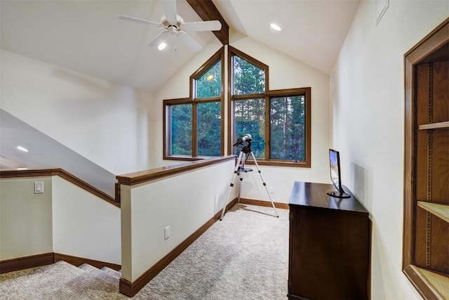 carpeted office space with vaulted ceiling with beams and ceiling fan