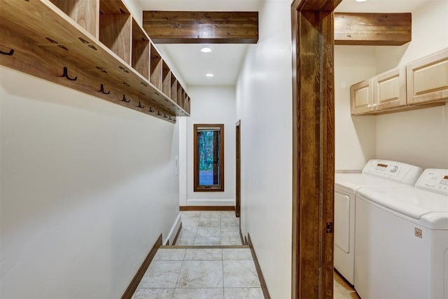 laundry room featuring light tile patterned flooring, cabinets, and separate washer and dryer