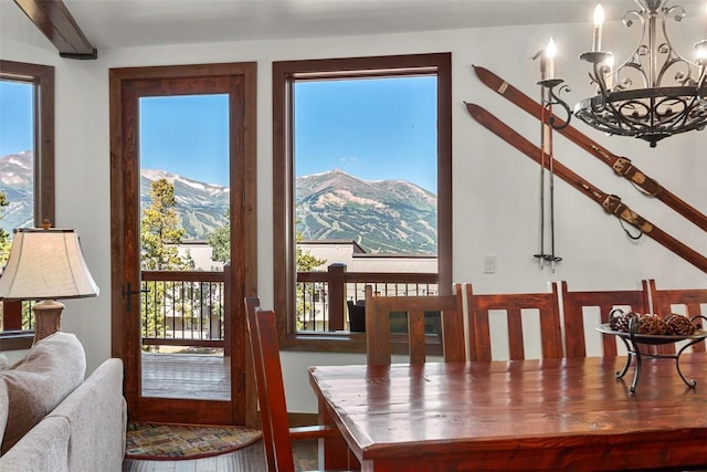 dining space featuring an inviting chandelier and a mountain view