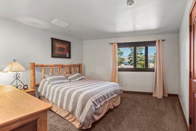 carpeted bedroom featuring baseboards