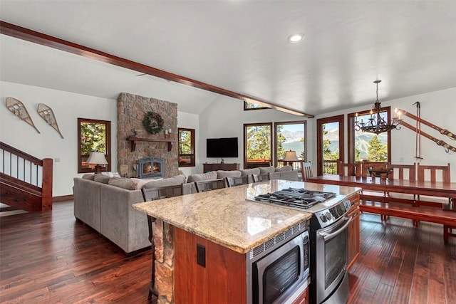 kitchen with lofted ceiling with beams, an inviting chandelier, stainless steel appliances, and dark wood-style flooring