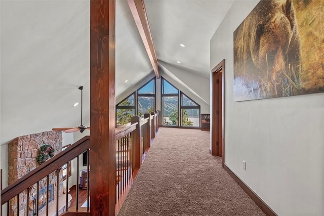 corridor with an upstairs landing, carpet, vaulted ceiling with beams, and baseboards