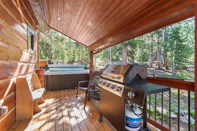 deck featuring a hot tub and grilling area