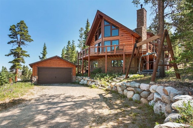 view of front facade featuring stone siding, an outdoor structure, a chimney, and a detached garage