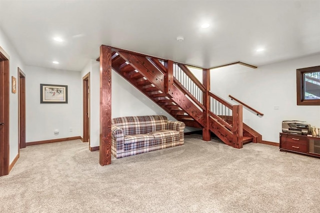 carpeted living area featuring baseboards, stairway, and recessed lighting