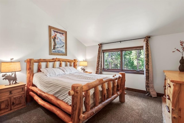 carpeted bedroom with baseboards and vaulted ceiling