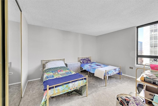 carpeted bedroom featuring a textured ceiling