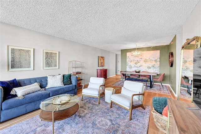 living room featuring hardwood / wood-style flooring, a textured ceiling, and a chandelier