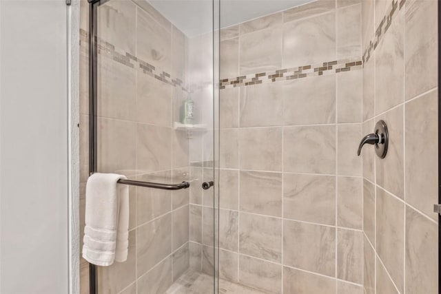 bathroom with a shower with shower door