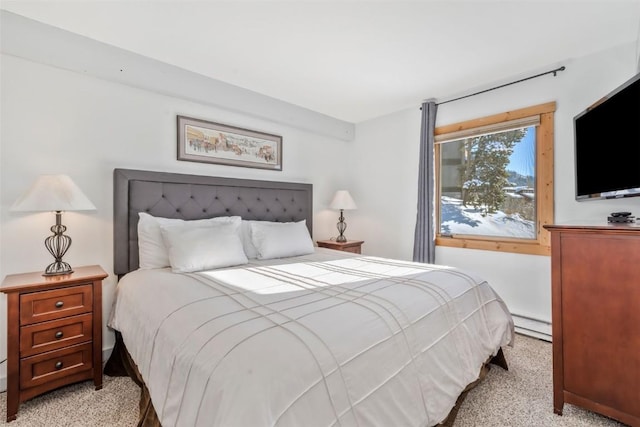 carpeted bedroom with a baseboard radiator