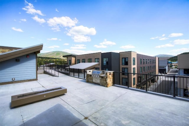 view of patio with a mountain view and area for grilling