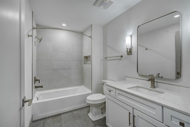 full bathroom featuring tile patterned floors, toilet, vanity, and tiled shower / bath