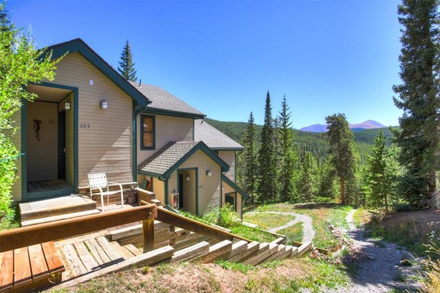 rear view of property with a deck with mountain view