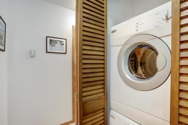 washroom with stacked washer and dryer