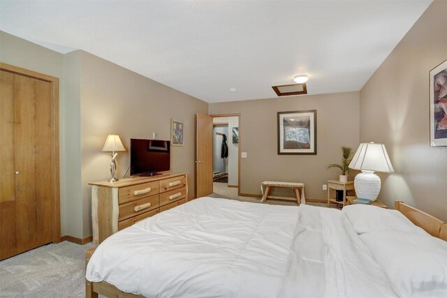 bedroom with light carpet and a closet