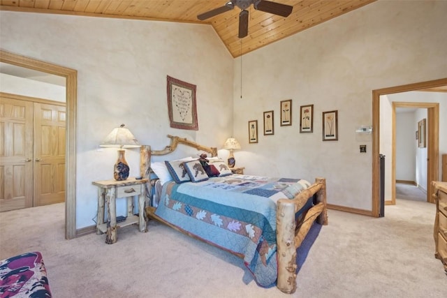 carpeted bedroom featuring ceiling fan, a closet, high vaulted ceiling, and wooden ceiling