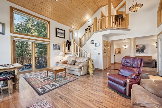 living room with hardwood / wood-style floors, wood ceiling, and a high ceiling