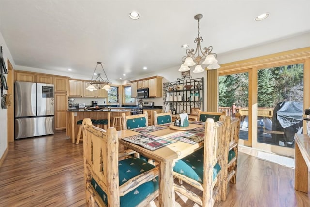 dining space featuring dark hardwood / wood-style floors and a notable chandelier