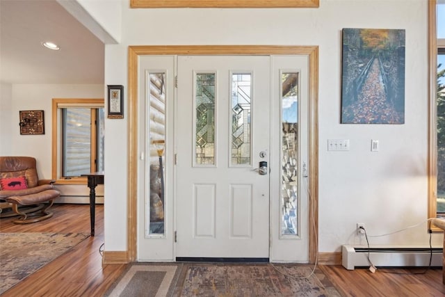 entryway with baseboard heating and dark wood-type flooring