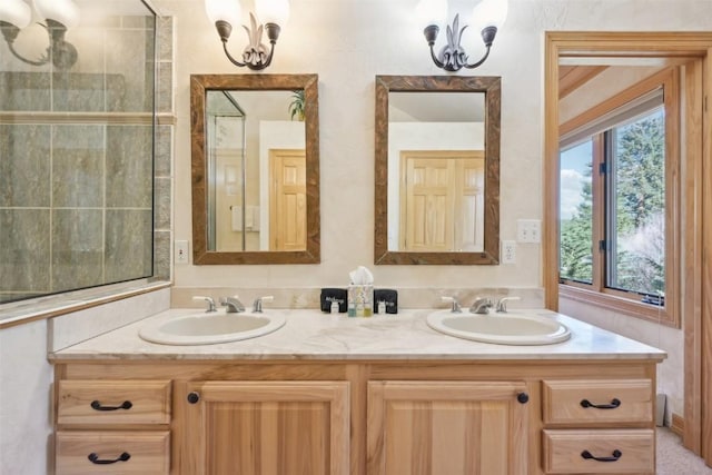 bathroom featuring a notable chandelier, plenty of natural light, and vanity